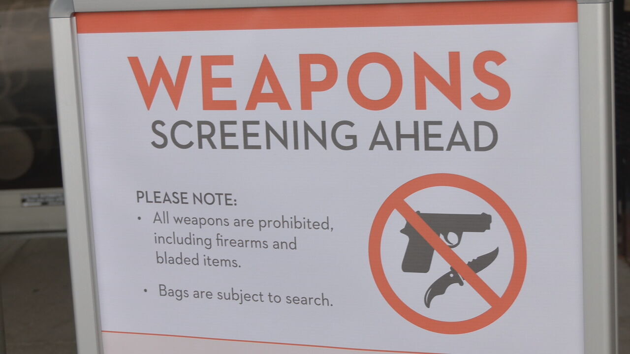 Sign alerting customers to weapons screening area